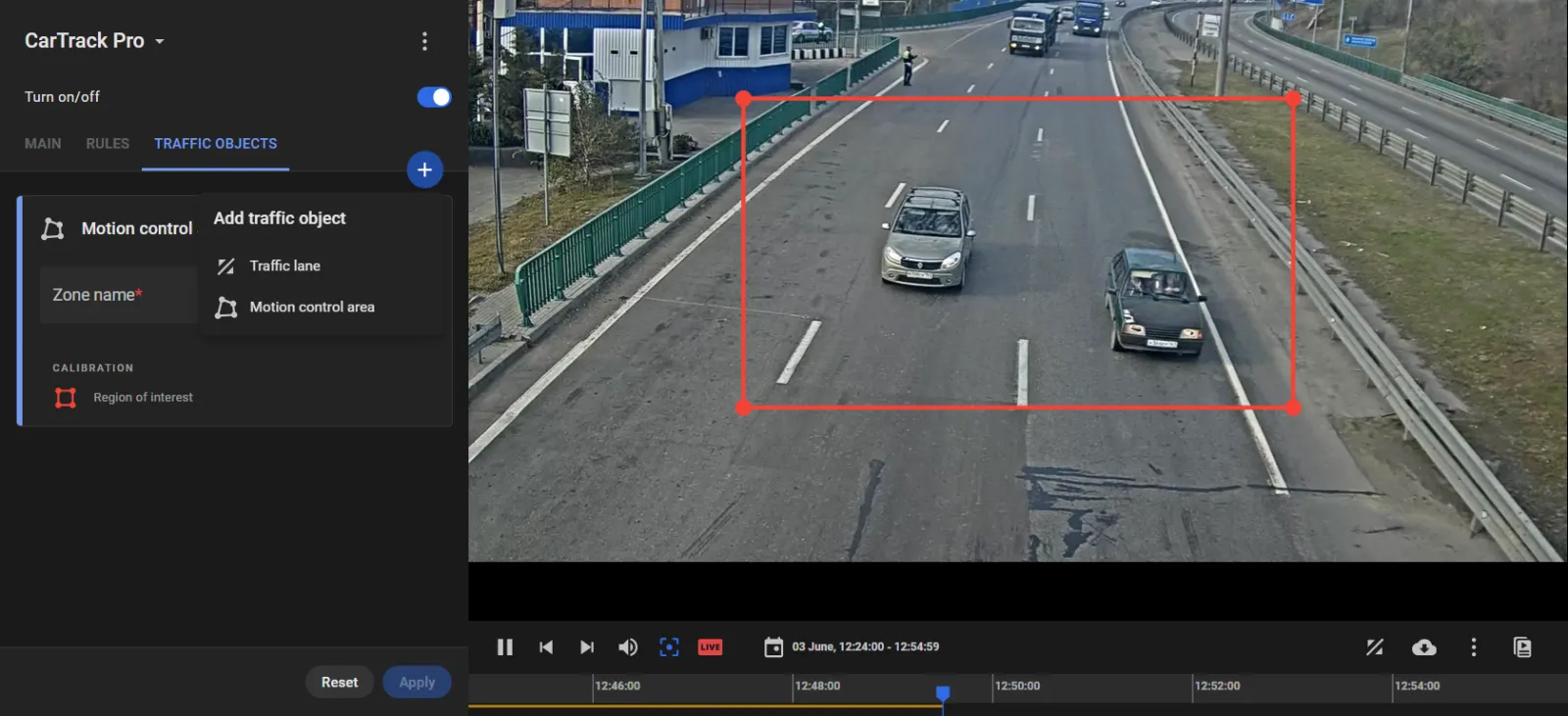 CarTrack Pro Traffic objects tab with the Add traffic object menu open showing Motion control area, and a Region of interest frame drawn around a road segment in the camera feed