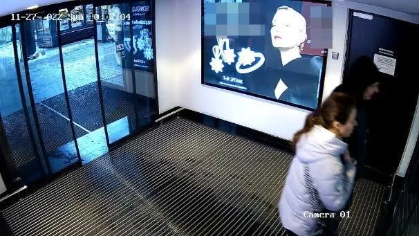 Bad camera placement example: a wide lobby view where a woman walks in from a distance, too far from the camera for a reliable face size