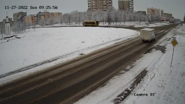 Bad camera mount example: wide, high-angle view of a snowy road with vehicles too distant for the plates to be read