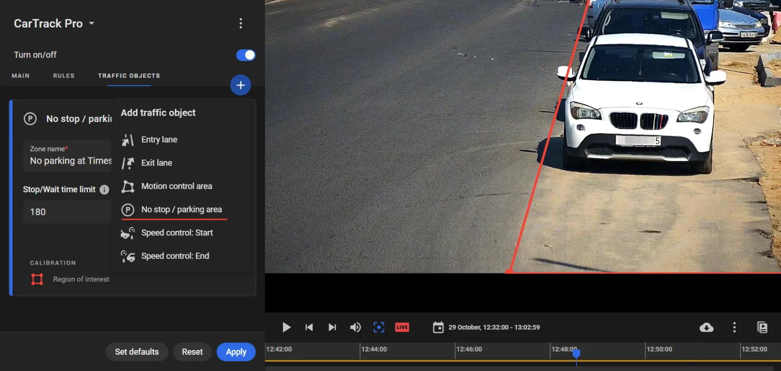 CarTrack Pro Traffic Objects tab with No stop / parking area selected from the Add traffic object menu, zone name and stop time limit set, and a red boundary line drawn in the camera view