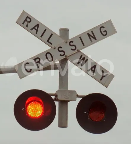 Railway crossing traffic light with the flashing red do-not-go signal illuminated