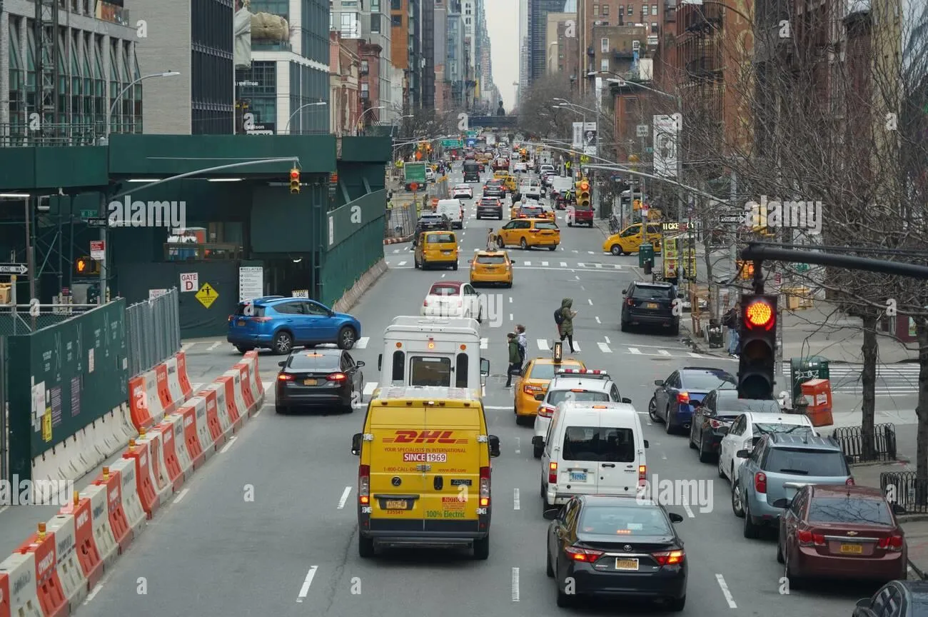Dense city traffic on a multi-lane street, an example of high traffic density with a camera directed along the traffic