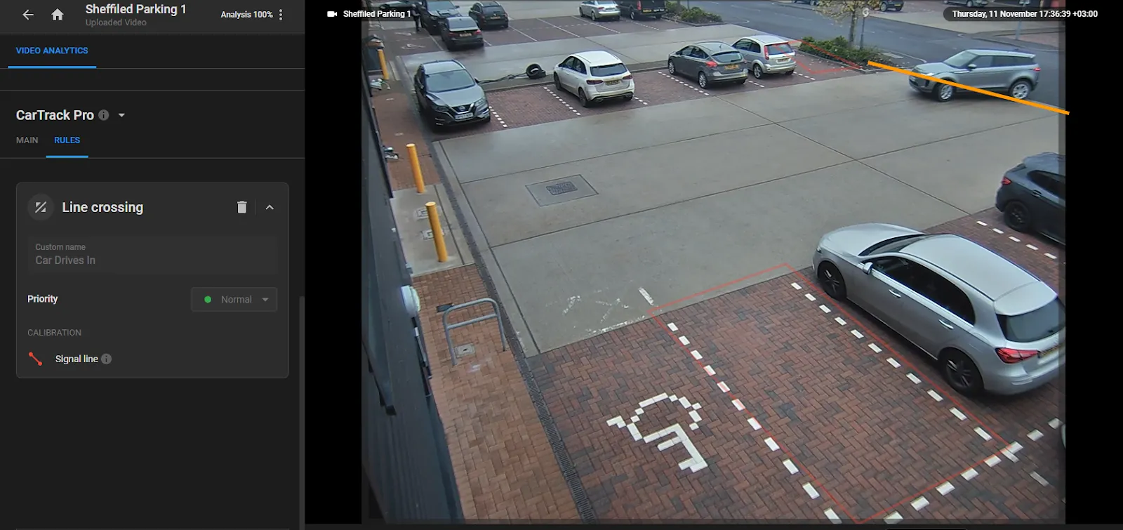 Parking lot camera feed with a Line crossing rule named Car Drives In, Priority set to Normal, and a signal line drawn across the entrance