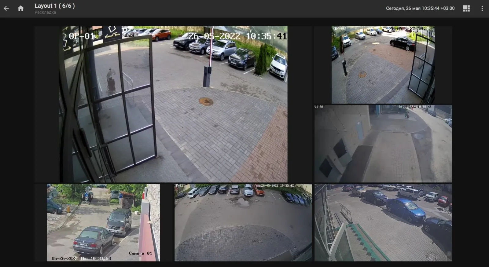 Video wall layout displaying six camera feeds of parking lots and building entrances at once